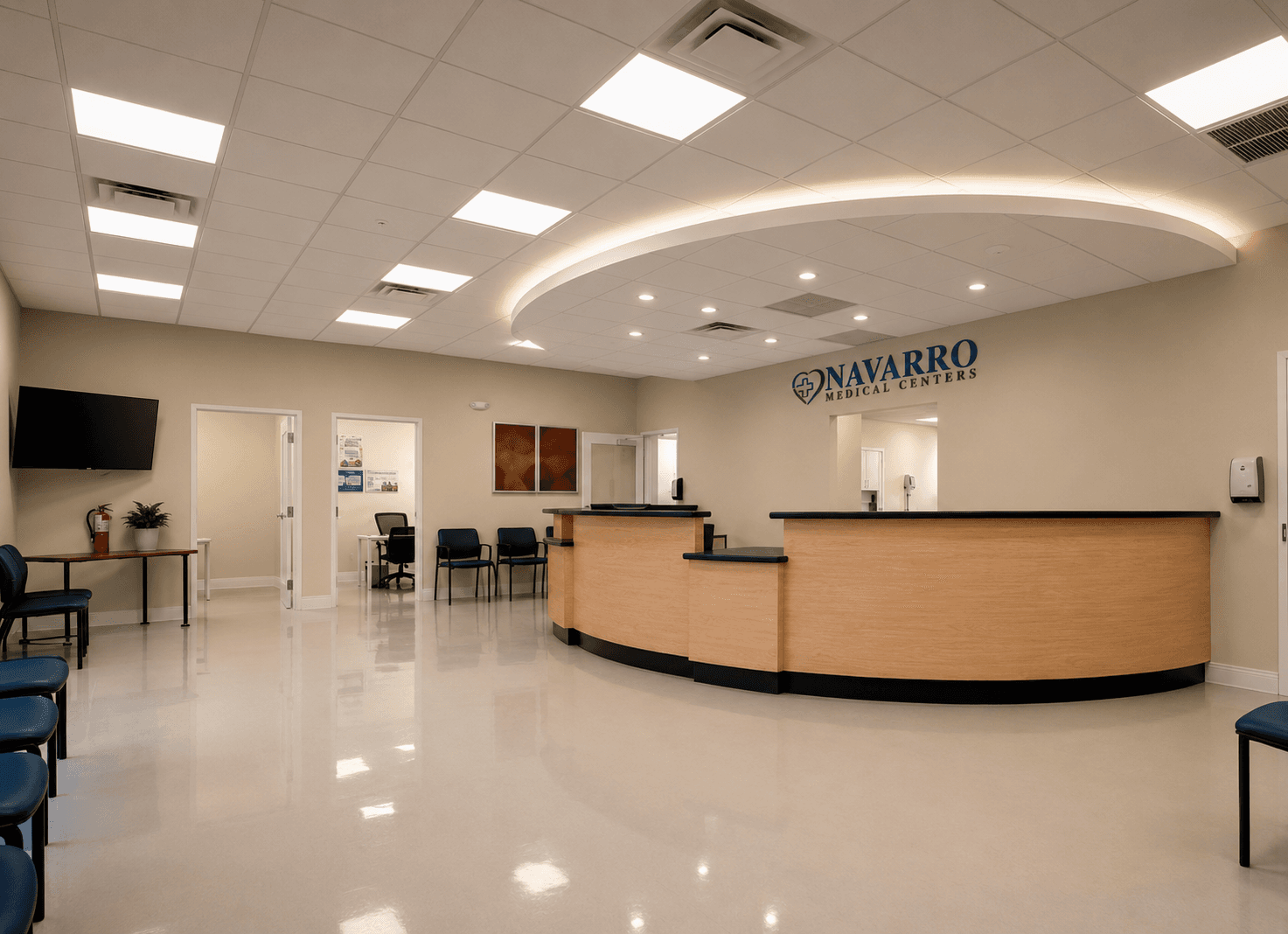Navarro Medical Centers reception area with a curved wood counter and illuminated wall sign