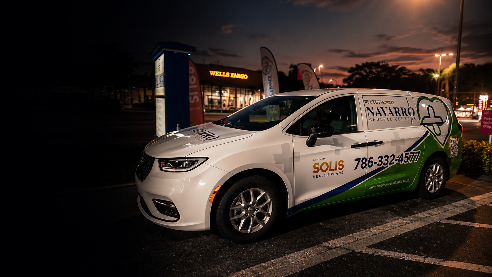 Navarro Medical Centers passenger van with a full brand wrap parked in a plaza at dusk